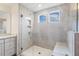 Modern walk-in shower features gray tiling, built-in bench, niche, and glass surround for spa-like experience at 85 Kissington Way, Benson, NC 27504