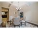 Elegant dining area with a chandelier and view of the kitchen at 8916 Buffalo Gourd Ln, Angier, NC 27501