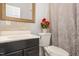 Bathroom with dark vanity, toilet, and shower at 105 Kingfisher Way, Louisburg, NC 27549