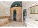 Primary bathroom with stone shower and bathtub at 105 Kingfisher Way, Louisburg, NC 27549