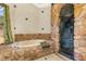 Bathroom with stone tub and shower, and a large window at 105 Kingfisher Way, Louisburg, NC 27549