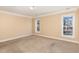 Bedroom with neutral walls, carpet, and multiple windows at 105 Kingfisher Way, Louisburg, NC 27549