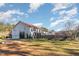 House exterior showcasing a large home with a red tile roof and a large backyard at 105 Kingfisher Way, Louisburg, NC 27549