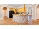 Kitchen with island, granite counters, and wood cabinets at 105 Kingfisher Way, Louisburg, NC 27549