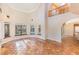 Bright living room featuring tile floors and a view to the pool at 105 Kingfisher Way, Louisburg, NC 27549