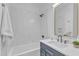 Clean bathroom with a tub, dark vanity and modern fixtures at 1105 Glascock St # 101, Raleigh, NC 27610