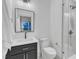 Stylish modern bathroom featuring a sleek vanity, toilet, and glass-enclosed shower at 1105 Glascock St # 102, Raleigh, NC 27610
