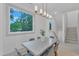 Dining room featuring a modern table, stylish chairs, a chandelier, and windows overlooking the greenery at 1105 Glascock St # 102, Raleigh, NC 27610