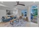 Living room with access to deck, featuring a blue sofa and armchairs at 1105 Glascock St # 102, Raleigh, NC 27610