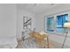 Bright office with a desk, white chairs and a large window at 1105 Glascock St # 102, Raleigh, NC 27610