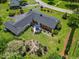 Aerial view of a home with a patio, lush greenery, and meticulous landscaping at 127 Fairfield Cir, Dunn, NC 28334