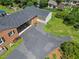 Aerial view of a home with a large driveway, garage, and well-maintained lawn at 127 Fairfield Cir, Dunn, NC 28334