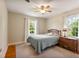 Comfortable bedroom with a neutral color scheme, ceiling fan, and two windows at 127 Fairfield Cir, Dunn, NC 28334