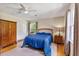 Bright bedroom featuring a blue bedspread, ceiling fan, and hardwood floors at 127 Fairfield Cir, Dunn, NC 28334