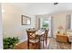 Dining room with hardwood floors, a wooden table, and natural light from the window at 127 Fairfield Cir, Dunn, NC 28334