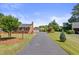A long driveway leads to this charming home with mature landscaping and an attached workshop at 127 Fairfield Cir, Dunn, NC 28334
