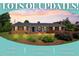Charming brick home featuring manicured lawn, mature landscaping, and an inviting rocking chair front porch at 127 Fairfield Cir, Dunn, NC 28334