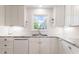 Bright and clean kitchen features white cabinets, granite countertops, and stainless appliances at 127 Fairfield Cir, Dunn, NC 28334