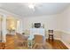 Well-lit living area with wicker chairs, light wood flooring and subtle wall-to-wall paneling at 127 Fairfield Cir, Dunn, NC 28334