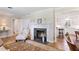 Comfortable living room with a fireplace, hardwood floors, and an adjacent kitchen at 127 Fairfield Cir, Dunn, NC 28334