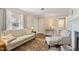 Cozy living room featuring hardwood floors, neutral paint, a decorative fireplace and lots of natural light at 127 Fairfield Cir, Dunn, NC 28334