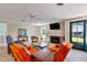 Bright living room featuring orange accent chairs, a fireplace, and a ceiling fan at 127 Fairfield Cir, Dunn, NC 28334