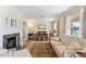 Bright living room featuring a fireplace, hardwood floors, a comfortable sofa, and a dining area at 127 Fairfield Cir, Dunn, NC 28334