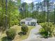 Charming single-story home featuring a landscaped front yard and a winding driveway at 1408 Ferrell Ct, Creedmoor, NC 27522