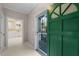 Bright foyer showcasing a vibrant green front door and a glimpse into the kitchen at 1408 Ferrell Ct, Creedmoor, NC 27522