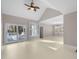 A light-filled living room boasts high ceilings, a ceiling fan, and outdoor access at 1408 Ferrell Ct, Creedmoor, NC 27522