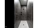 Sleek bathroom shower with dark tile surround and pebble tile floor at 145 Ottawa Dr, Louisburg, NC 27549