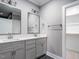 Elegant bathroom featuring dual sinks, modern fixtures, and a walk-in closet at 145 Ottawa Dr, Louisburg, NC 27549