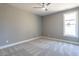 Neutral bedroom with large window and ceiling fan at 145 Ottawa Dr, Louisburg, NC 27549