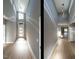 Bright foyer with hardwood flooring, high ceilings, modern lighting, and a view of the front door at 145 Ottawa Dr, Louisburg, NC 27549