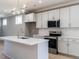 Modern kitchen features stainless steel appliances, gray cabinets, and a tiled backsplash at 145 Ottawa Dr, Louisburg, NC 27549