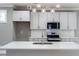 Bright kitchen showcasing stainless steel appliances, gray cabinets, and a tiled backsplash at 145 Ottawa Dr, Louisburg, NC 27549