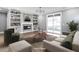 Bright living room features custom built-ins, fireplace, and sliding glass doors, staged with modern furnishings at 145 Ottawa Dr, Louisburg, NC 27549