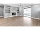 Bright living room features wood floors, built-in shelves, fireplace, and sliding glass doors to the backyard at 145 Ottawa Dr, Louisburg, NC 27549