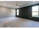Spacious main bedroom features a board and batten accent wall, carpet and large windows at 145 Ottawa Dr, Louisburg, NC 27549