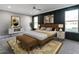 Staged main bedroom with accent wall, a cozy bed, and stylish furniture at 145 Ottawa Dr, Louisburg, NC 27549