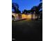 Side view of the well lit home at dusk with a ramp leading up to the screened in porch at 1521 Cross Link Rd, Raleigh, NC 27610