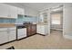Vintage eat-in kitchen with stainless steel appliances and retro blue tile backsplash and checkered linoleum flooring at 1521 Cross Link Rd, Raleigh, NC 27610