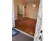 View from the front door into the foyer and living room with decorative light fixture and hardwood floors at 1521 Cross Link Rd, Raleigh, NC 27610