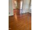 Hardwood floors and decorative molding featured in this living room with a light fixture and a doorway at 1521 Cross Link Rd, Raleigh, NC 27610