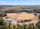 An aerial view of the baseball fields, treeline, neighborhood and sky at 4708 River Boat Landing Ct, Raleigh, NC 27604