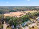 An aerial view of the baseball fields, tree line, neighborhood and sky at 4708 River Boat Landing Ct, Raleigh, NC 27604