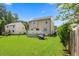 Lovely backyard featuring a well-maintained lawn, a wooden fence, and a charming house with a deck at 4708 River Boat Landing Ct, Raleigh, NC 27604