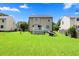 A large, lush backyard featuring mature landscaping with a deck and stairs at 4708 River Boat Landing Ct, Raleigh, NC 27604
