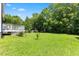 Expansive backyard with lush greenery, a wooden deck, and a charming landscape, creating a serene outdoor space at 4708 River Boat Landing Ct, Raleigh, NC 27604