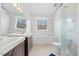 Well-lit bathroom featuring a large tub, walk-in shower, and double vanity at 4708 River Boat Landing Ct, Raleigh, NC 27604